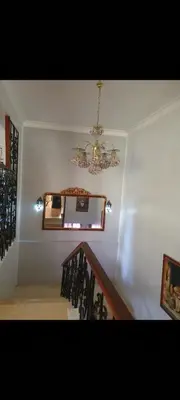 a chandelier hanging over a staircase in a house at Soliman Villa in Luxor