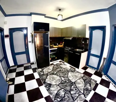 a kitchen with a black and white checkered floor at hurghada home in Safaga