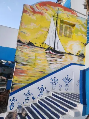 a painting of a sail boat on the side of a building at Endo Mando in Shellal