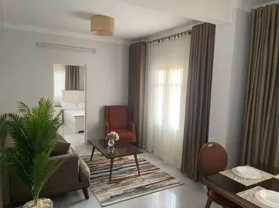 a living room with a couch and a chair and a table at Tony HOUSE in Aswan