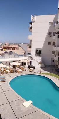 a swimming pool in front of a building at Tiba view in Hurghada