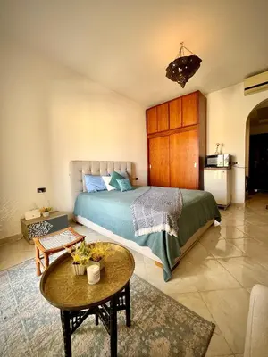 a bedroom with a bed and a table in a room at luxury Beachfront Studio- Foreign Nationals Only in Hurghada