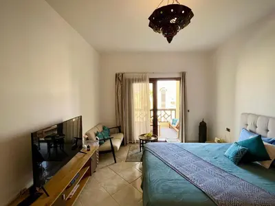 a bedroom with a bed and a living room at luxury Beachfront Studio- Foreign Nationals Only in Hurghada