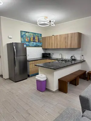 a kitchen with a refrigerator and a counter top at Bali c 3 D in Hurghada