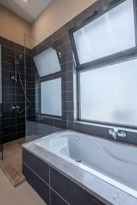 a bathroom with a large tub and a window at 4BR Villa with Private Pool Tawila Lagoon El Gouna in Hurghada