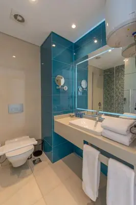 a bathroom with a toilet and a sink and a mirror at Royal Villa on the beach in Hurghada