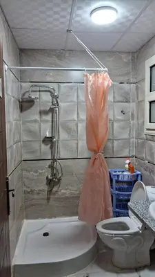 a bathroom with a tub and a toilet and a sink at Andalusia Resort - 2 Bedroom Apartment in Hurghada