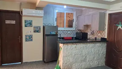a kitchen with a refrigerator and a counter top at Andalusia Resort - 2 Bedroom Apartment in Hurghada