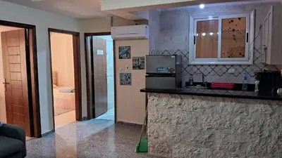 a kitchen with a counter and a bathroom with a tub at Andalusia Resort - 2 Bedroom Apartment in Hurghada