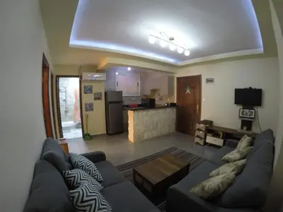 a living room with a couch and a kitchen at Andalusia Resort - 2 Bedroom Apartment in Hurghada