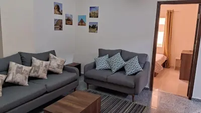 a living room with a couch and a chair at Andalusia Resort - 2 Bedroom Apartment in Hurghada