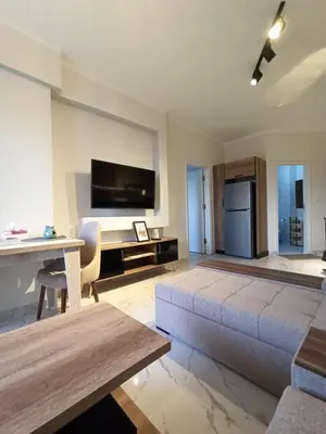 a living room with a couch and a tv at Juliana Beach Resort Hurghada in Hurghada