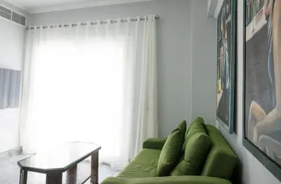 a living room with a green couch and a table at MB1-1-104 in Hurghada