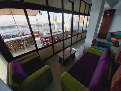 a living room with a couch and chairs and a table at Merry Land Hotel & Roof Top Nile Restaurant Luxor in Luxor