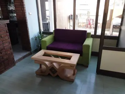 a living room with a couch and a coffee table at Merry Land Hotel & Roof Top Nile Restaurant Luxor in Luxor
