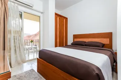 a bedroom with a bed and a large window at Lazur Sea & City Apartment's - El Hadaba, Hurghada - Egypt in Hurghada