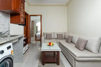 a living room with a couch and a table at Lazur Sea & City Apartment's - El Hadaba, Hurghada - Egypt in Hurghada
