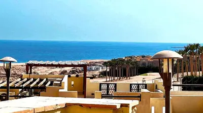 a view of a resort with the ocean in the background at Azzura appartment sahl hashesh with private garden in Hurghada