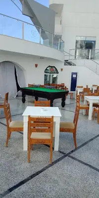 a room with a pool table and tables and chairs at Tibaview in Hurghada