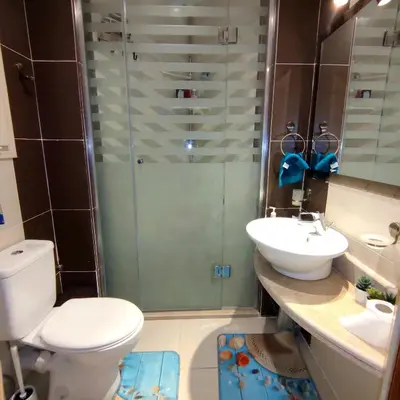 a bathroom with a shower and a toilet and a sink at Royal Beach G 05 in Hurghada