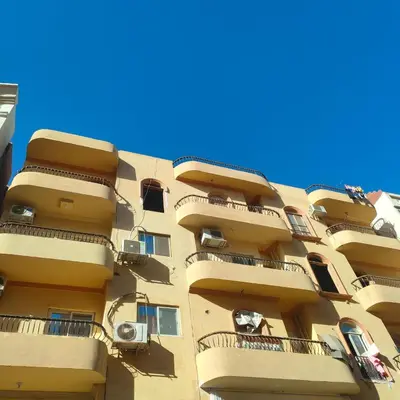 a tall apartment building with balconies on the side of it at Hurghada City Apartment1 in Hurghada