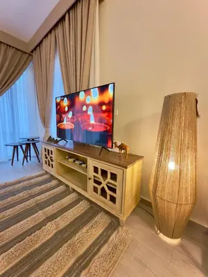 a living room with a flat screen tv on a stand at Luxury Villa Bali Al Gouna Hurgh in Hurghada