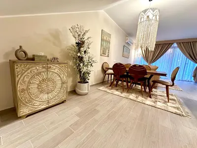 a dining room with a table and chairs and a dining room at Luxury Villa Bali Al Gouna Hurgh in Hurghada