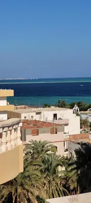a view of a building with the ocean in the background at Ahmed House 1 in Safaga