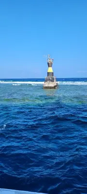 a lighthouse in the middle of a body of water at Ahmed House 1 in Safaga