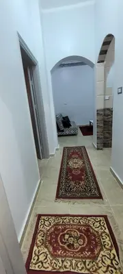 a hallway with two rugs on the floor in a room at Ahmed House 1 in Safaga