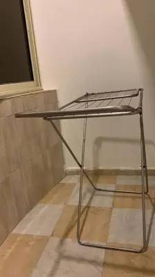 a metal chair sitting on a floor in a room at Уютная квартира в светлых тонах рядом с легендарной улицей Шератон в центре in Hurghada