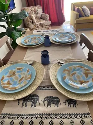a wooden table with blue plates on top of it at Glamorous 2BR/ Free Beach & Pool Access @ Mangroovy, El Gouna in Hurghada