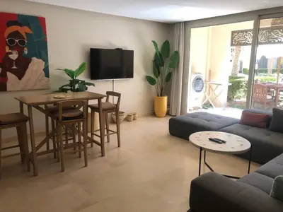 a living room with a couch and a table at Glamorous 2BR/ Free Beach & Pool Access @ Mangroovy, El Gouna in Hurghada
