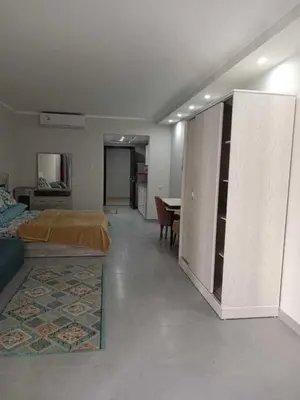 a bedroom with a bed and a table in it at Perfect For couples Sunny & SeaView with Wi-Fi in Hurghada