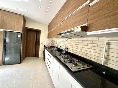 a kitchen with black counter tops and wooden cabinets at The view compound in Hurghada