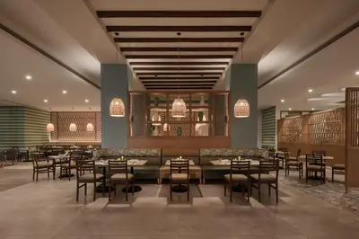 a restaurant with tables and chairs in a room at JAZ Elite Asteria in Hurghada