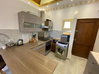 a kitchen with a washer and a washing machine at Makadi heights luxury apartment in Hurghada