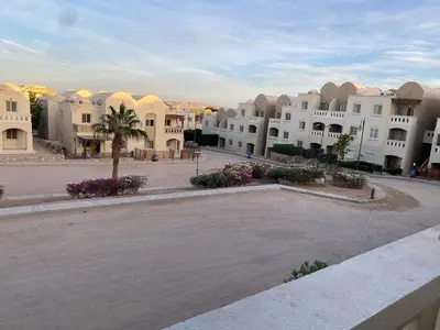 an empty parking lot in a town with white buildings at Makadi heights luxury apartment in Hurghada