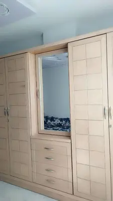 a large cabinet with a window in a room at Evi's Infinity Sea View Apartment in Hurghada