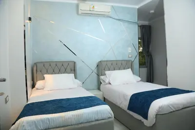 two beds sitting next to each other in a room at Crystala guest house in Aswan