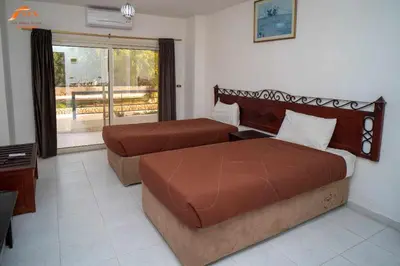 a hotel room with two beds and a window at Fox Resort El Gouna Stay in Hurghada