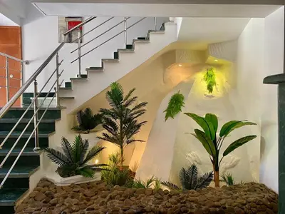 a room with a staircase with trees and plants at villa 5 in magawish in Hurghada