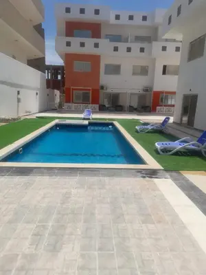 a swimming pool in the middle of a building at Alfayrouz house in Hurghada