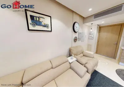 a living room with a couch and a clock on the wall at Stylish 1BR @ Mangroovy-M7-6B in Hurghada