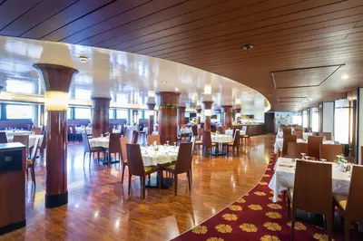 a dining room with tables and chairs in a restaurant at M/Y ALYSSA - 4 or 7 Nights From Luxor each Monday and 3 or 7 Nights From Aswan each Friday in Luxor