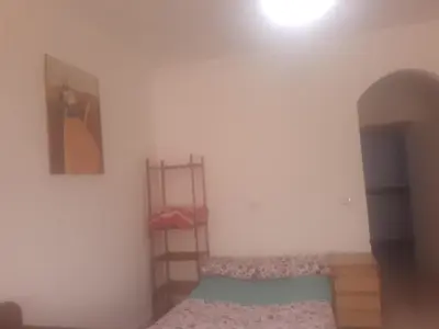 a room with a bed and a shelf in it at Sheraton Plaza Near Marina in Hurghada