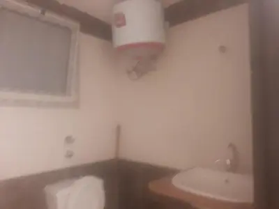 a bathroom with a toilet and a sink and a light at Sheraton Plaza Near Marina in Hurghada