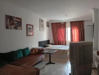 a living room with a couch and a bed at Sheraton Plaza Near Marina in Hurghada