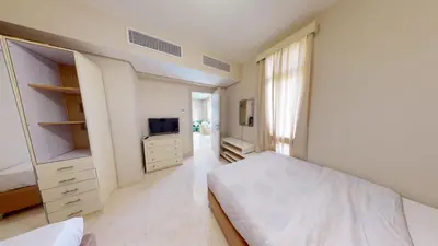 a white bedroom with a bed and a tv at Beautiful 2 Bed Rooms at Mangaroveey M7-4B-El-Gouna in Hurghada