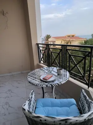 a table on a balcony with a table and chairs at Solo beach front studio or for couple in Hurghada